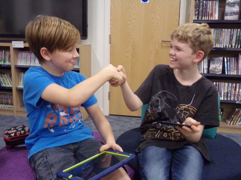 Two boarders laughing and shaking hands